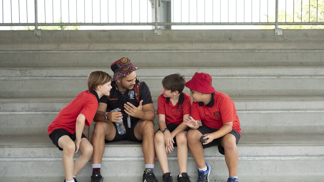 Man with three boys laughing