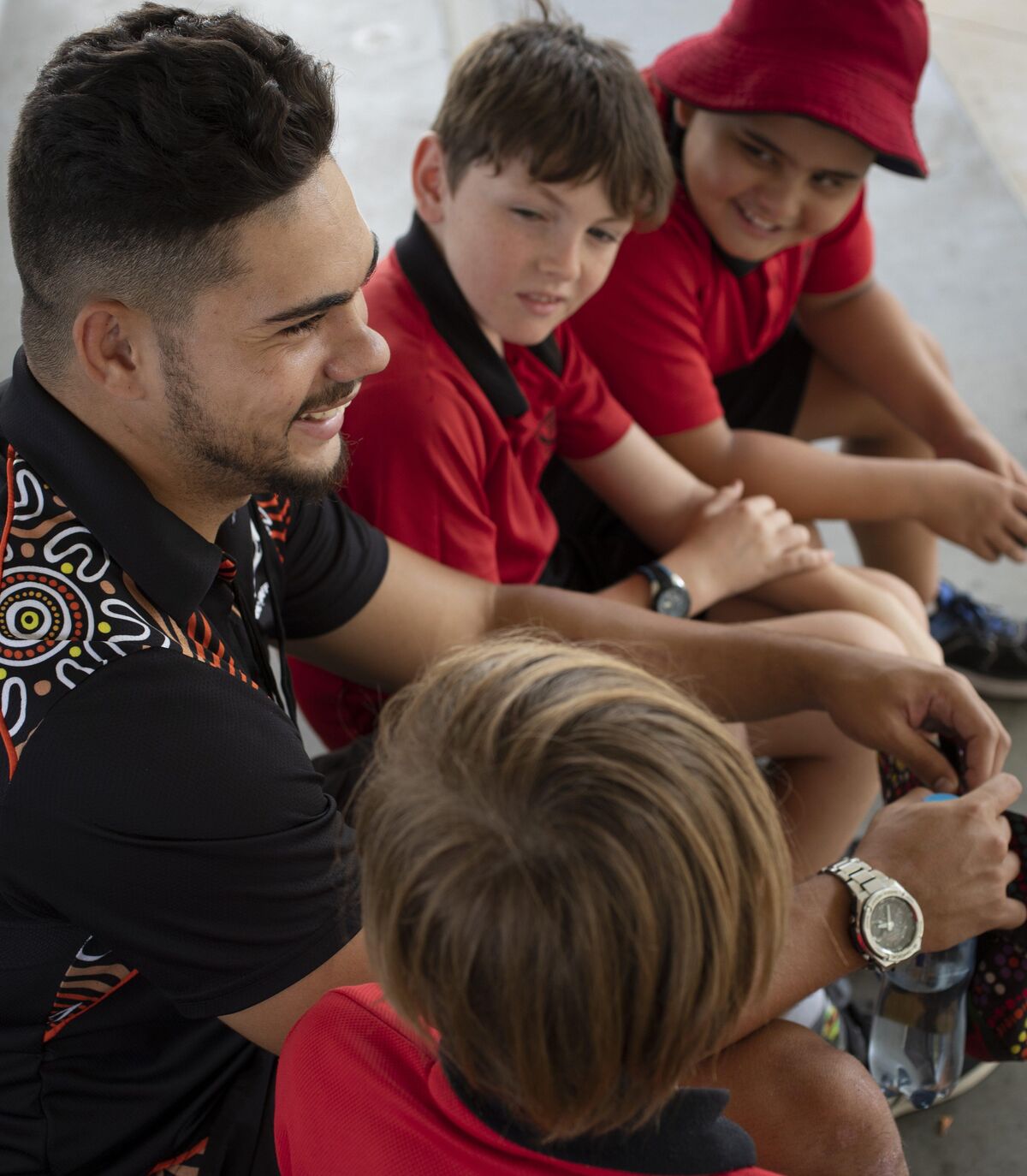 Educator and boys talking